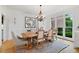 Elegant dining room with hardwood floors, large windows, and decorative lighting at 2430 Flat Stone Dr, Cumming, GA 30041
