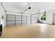 Spacious three car garage has epoxy flooring, three garage doors, and lots of room for storage at 2430 Flat Stone Dr, Cumming, GA 30041
