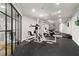 Home gym boasts full machines, rubber floor, ceiling fan, and views into the recreational area at 2430 Flat Stone Dr, Cumming, GA 30041