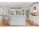 Well-lit kitchen with bar seating, stainless steel appliances, and custom white cabinetry at 2430 Flat Stone Dr, Cumming, GA 30041