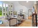 Bright living room with soaring ceilings, hardwood floors, and walls of windows at 2430 Flat Stone Dr, Cumming, GA 30041