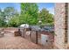Brick outdoor kitchen with stainless steel grill, sink, refrigerator, and curved brick bench seating at 2430 Flat Stone Dr, Cumming, GA 30041