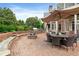 Large brick patio with a fire pit, dining table, and outdoor kitchen area at 2430 Flat Stone Dr, Cumming, GA 30041