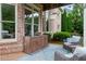 Cozy brick patio with outdoor furniture and a wooden cabinet for outdoor living at 2430 Flat Stone Dr, Cumming, GA 30041