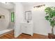 Bright bathroom featuring a modern vanity, neutral walls, wood-look flooring and walk-in shower at 4818 Terrace Green Trce, Stone Mountain, GA 30088