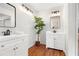 Bathroom featuring double vanities and modern fixtures, set against clean white walls and wood-look flooring at 4818 Terrace Green Trce, Stone Mountain, GA 30088