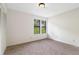 An empty bedroom with plush carpeting, neutral walls, and a double window for natural light at 4818 Terrace Green Trce, Stone Mountain, GA 30088