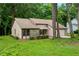 Inviting single-story home with light beige siding, a stone facade, and surrounded by mature trees at 4818 Terrace Green Trce, Stone Mountain, GA 30088