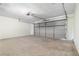 Spacious two car garage with a clean concrete floor and plenty of room for parking and storage at 4818 Terrace Green Trce, Stone Mountain, GA 30088