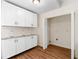 Laundry room featuring sleek white cabinets and granite countertops with a large open space at 4818 Terrace Green Trce, Stone Mountain, GA 30088