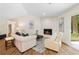 Comfortable living room features a stone fireplace and sliding glass door with views of the lush greenery at 4818 Terrace Green Trce, Stone Mountain, GA 30088
