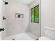 An updated walk-in shower with a frameless glass door, neutral tile, and modern fixtures at 4818 Terrace Green Trce, Stone Mountain, GA 30088