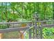 Unique backyard fence with a whimsical lizard decoration overlooking greenery and plants at 6520 Indian Acres Trl, Tucker, GA 30084