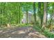 Lush backyard with view of the house and surrounding green trees at 6520 Indian Acres Trl, Tucker, GA 30084