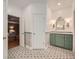 Charming bathroom featuring a green vanity and ornate decorative tile floor at 6520 Indian Acres Trl, Tucker, GA 30084
