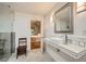 Bright bathroom with a sleek sink, large mirror, and stylish lighting fixtures, with a bedroom through the door at 6520 Indian Acres Trl, Tucker, GA 30084