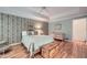 Comfortable bedroom with tray ceilings, hardwood floors, and serene decor at 6520 Indian Acres Trl, Tucker, GA 30084