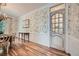 Dining room with floral wallpaper, chandelier and view into the kitchen at 6520 Indian Acres Trl, Tucker, GA 30084