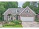 Charming brick home featuring an attached two-car garage and professionally landscaped front yard at 6520 Indian Acres Trl, Tucker, GA 30084