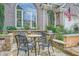 Seating area amidst stone patio and landscaping, with view of home's brick exterior at 6520 Indian Acres Trl, Tucker, GA 30084