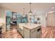 Open kitchen with a large island, hardwood floors, modern appliances, and views into the living room at 6520 Indian Acres Trl, Tucker, GA 30084
