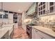 Charming kitchen features custom cabinets, brick backsplash, stainless steel appliances, and farmhouse sink at 6520 Indian Acres Trl, Tucker, GA 30084