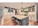 Bright kitchen with island, ample storage, hardwood floors, and custom hood at 6520 Indian Acres Trl, Tucker, GA 30084