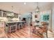 Eat-in kitchen with granite countertops, center island, pendant lighting, and wood floors at 6520 Indian Acres Trl, Tucker, GA 30084
