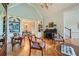 Living room featuring wood floors, built-in bookshelves, and view into dining room at 6520 Indian Acres Trl, Tucker, GA 30084