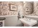 Charming powder room with floral wallpaper, pedestal sink, and stylish decor at 6520 Indian Acres Trl, Tucker, GA 30084