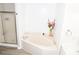 Well-lit bathroom with corner tub and a shower at 9130 Charlton Pl, Douglasville, GA 30135