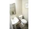 Small bathroom showcasing a sleek sink, toilet, a framed mirror, and modern light fixtures, designed for efficiency and style at 9130 Charlton Pl, Douglasville, GA 30135