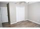 Bedroom featuring neutral walls and hardwood floors, and a spacious closet, perfect for creating a serene and organized retreat at 9130 Charlton Pl, Douglasville, GA 30135
