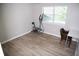 Bright bedroom featuring durable hardwood floors and ample natural light from a large window at 9130 Charlton Pl, Douglasville, GA 30135