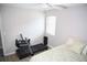 Bedroom with hardwood floors, ceiling fan and a stationary bike, offering a bright space for relaxation and exercise at 9130 Charlton Pl, Douglasville, GA 30135