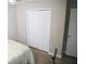 Bedroom features laminate floors, a built-in closet with folding doors, and neutral walls providing a simple and comfortable space at 9130 Charlton Pl, Douglasville, GA 30135