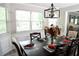 Dining room features large windows, a modern chandelier, and seating for six at 9130 Charlton Pl, Douglasville, GA 30135