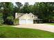 Charming yellow two-story home showcasing an attached two-car garage and well-maintained lawn at 9130 Charlton Pl, Douglasville, GA 30135