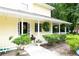 Close-up of a home's charming front porch with manicured landscaping and decorative hanging plants at 9130 Charlton Pl, Douglasville, GA 30135