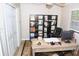 Cozy office space with a work desk, shelving, storage closet, and lots of natural light at 9130 Charlton Pl, Douglasville, GA 30135