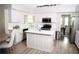 Modern kitchen with an island, stainless steel appliances, and white cabinetry at 9130 Charlton Pl, Douglasville, GA 30135