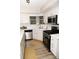 Modern kitchen showcasing stainless steel appliances, white cabinetry, granite countertops, and ample natural light at 9130 Charlton Pl, Douglasville, GA 30135