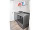 Functional laundry room showcasing modern washer and dryer units, storage shelves, and a clean, well-lit space at 9130 Charlton Pl, Douglasville, GA 30135