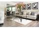 Bright, modern living room featuring stylish decor, neutral tones, and an open view into the dining area at 9130 Charlton Pl, Douglasville, GA 30135