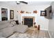 Living room with fireplace, hardwood floors, modern furniture, and natural light at 9130 Charlton Pl, Douglasville, GA 30135