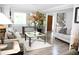Living room with hardwood floors, big windows, a modern coffee table and decor at 9130 Charlton Pl, Douglasville, GA 30135