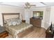 This is a main bedroom featuring hardwood floors, and a large dresser with a big mirror on top at 9130 Charlton Pl, Douglasville, GA 30135