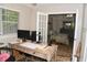 Bright office area with a work desk, view to the main bedroom, and natural light at 9130 Charlton Pl, Douglasville, GA 30135