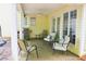 This covered patio offers an outdoor dining and grilling space with neutral furniture at 9130 Charlton Pl, Douglasville, GA 30135