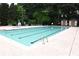 Community pool framed by lush landscaping offers a refreshing escape with poolside seating at 9130 Charlton Pl, Douglasville, GA 30135